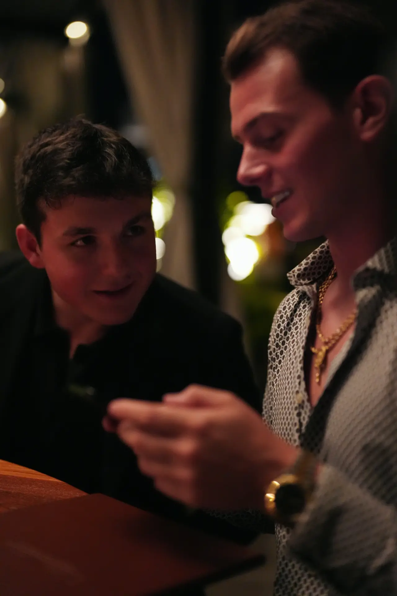 Cole DeFranco in conversation with a client at night